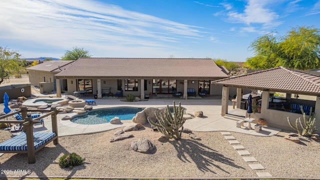 view of pool featuring a patio area and an in ground hot tub