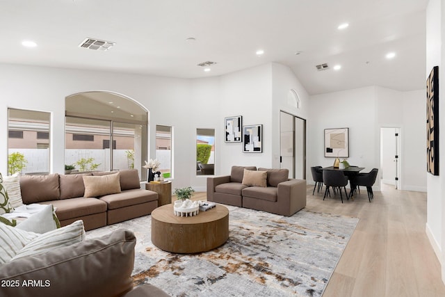 living area with recessed lighting, visible vents, and light wood-style floors