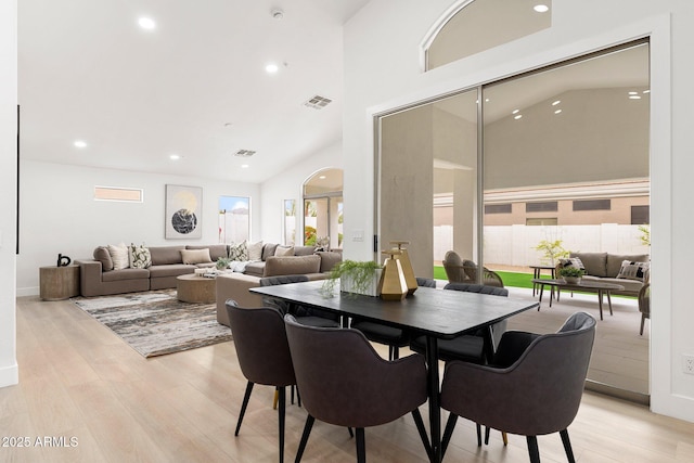 dining room featuring visible vents, recessed lighting, high vaulted ceiling, and light wood-style floors