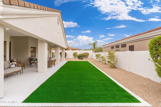 view of yard featuring a patio area, an outdoor hangout area, and a fenced backyard