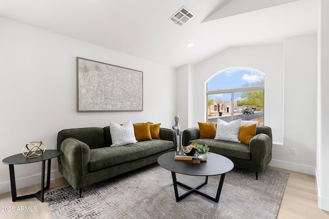 living room with light wood finished floors, visible vents, baseboards, vaulted ceiling, and recessed lighting