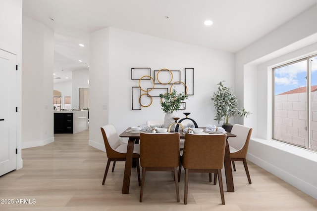 dining area featuring recessed lighting, baseboards, and light wood finished floors