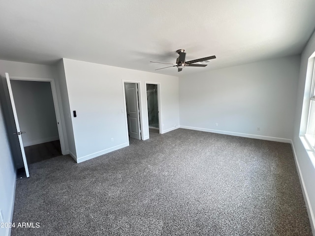 unfurnished bedroom featuring ceiling fan and dark colored carpet