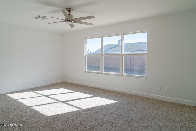 empty room featuring a mountain view, ceiling fan, and carpet flooring