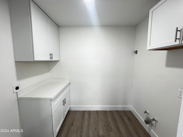 washroom featuring cabinets, dark hardwood / wood-style floors, and electric dryer hookup