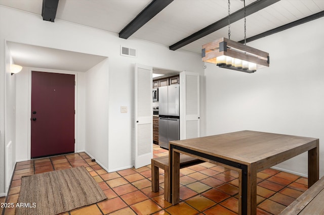 unfurnished dining area featuring beamed ceiling and light tile patterned flooring