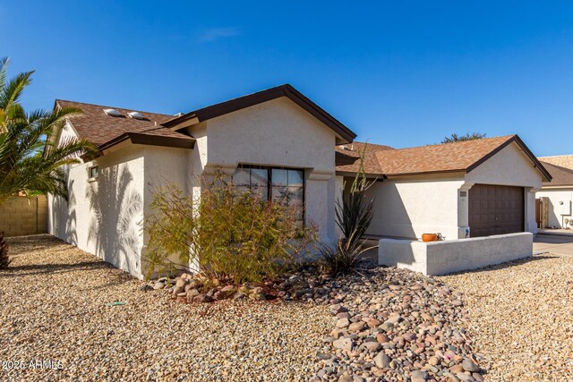 13918 N 78th Ave, Peoria, AZ 85381 - view of front of house featuring stucco siding, a garage, a shingled roof, and driveway
