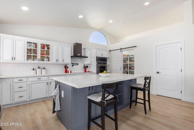 13918 N 78th Ave, Peoria, AZ 85381 - kitchen with wall chimney range hood, vaulted ceiling, decorative backsplash, white cabinetry, and built in microwave