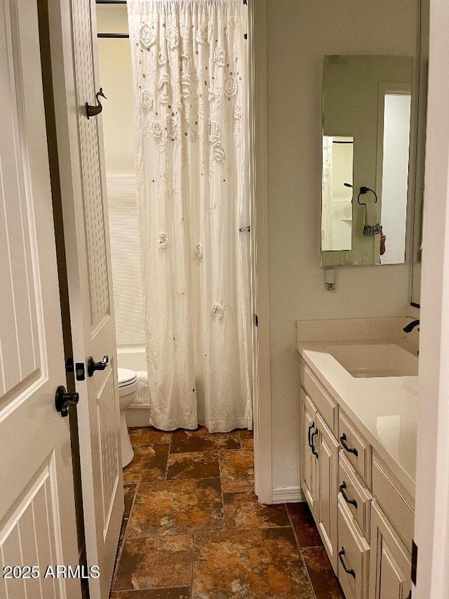 20502 W Ridge Rd, Buckeye, AZ 85396 - bathroom with vanity, stone finish flooring, and shower / bath combo