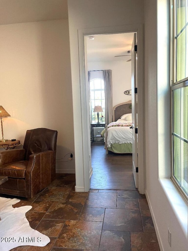 20502 W Ridge Rd, Buckeye, AZ 85396 - corridor with baseboards and stone tile floors