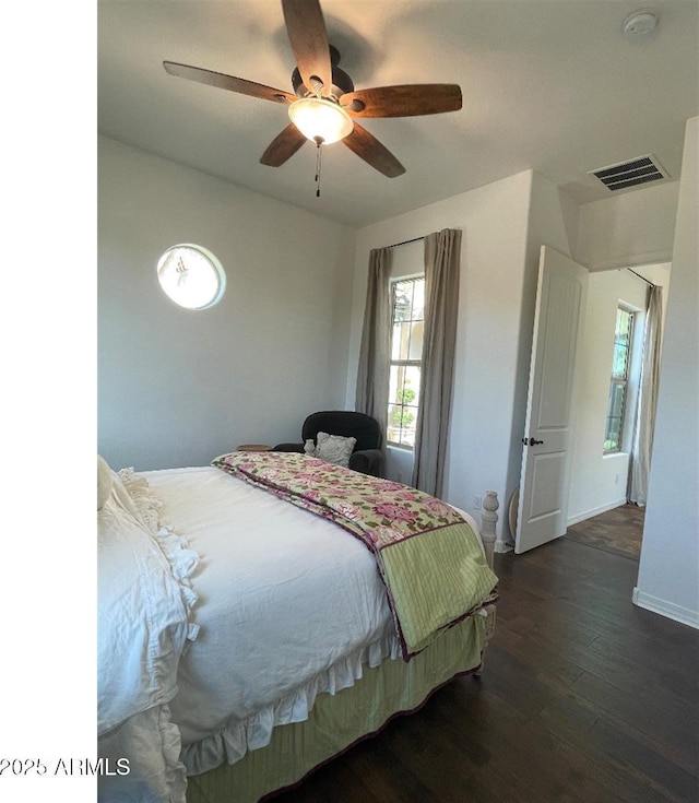 20502 W Ridge Rd, Buckeye, AZ 85396 - bedroom featuring wood finished floors, multiple windows, and a ceiling fan