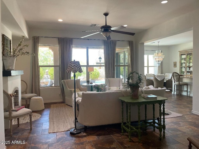 20502 W Ridge Rd, Buckeye, AZ 85396 - living area featuring stone tile flooring, healthy amount of natural light, ceiling fan, recessed lighting, and a chandelier