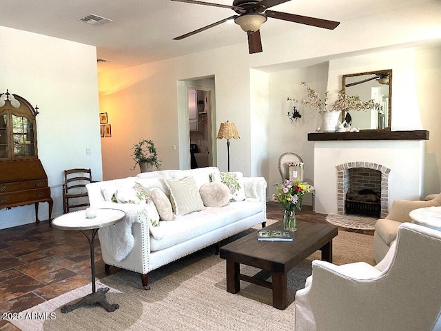 20502 W Ridge Rd, Buckeye, AZ 85396 - living area with a ceiling fan, a brick fireplace, and stone finish flooring