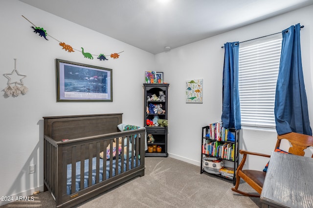 carpeted bedroom featuring a crib