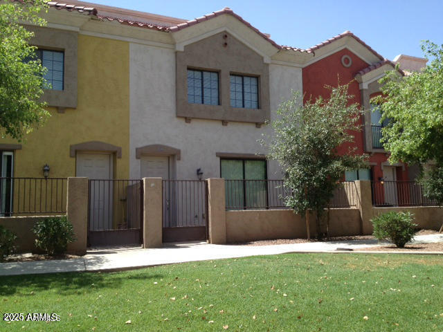 back of house with a lawn