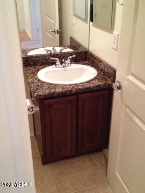 bathroom with tile patterned flooring and vanity