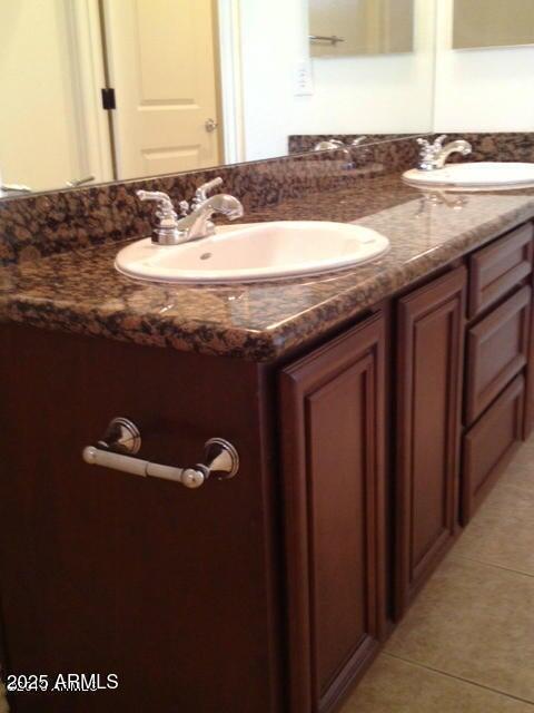 bathroom featuring tile patterned flooring and vanity