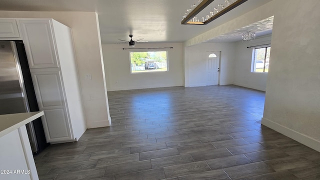 interior space featuring dark wood-type flooring, plenty of natural light, and ceiling fan