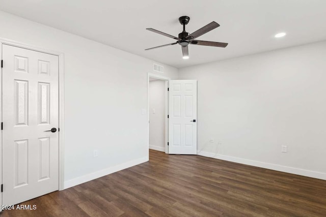 spare room with ceiling fan and dark hardwood / wood-style flooring