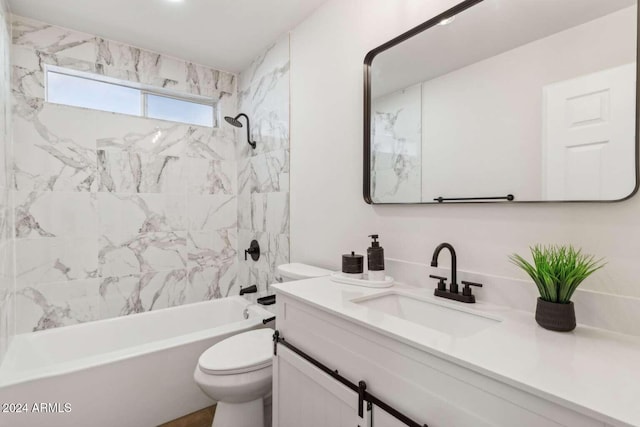 full bathroom with tiled shower / bath combo, vanity, and toilet