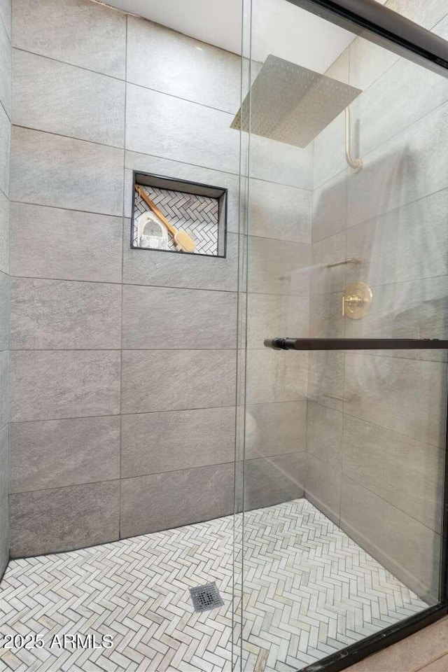 bathroom featuring a shower with shower door