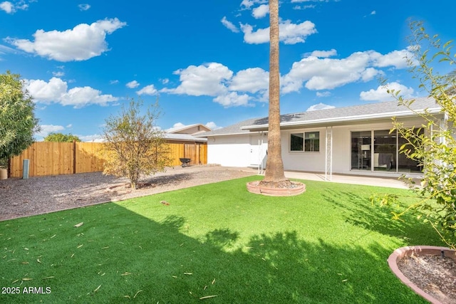 back of house featuring a yard and a patio area