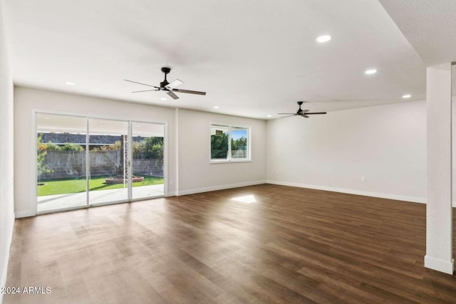 unfurnished living room featuring dark hardwood / wood-style flooring and ceiling fan