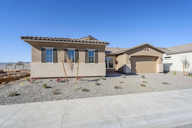 view of front of home with a garage and a mountain view