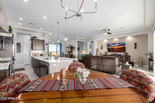 dining space with recessed lighting, visible vents, ceiling fan with notable chandelier, and baseboards