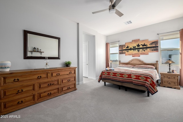 bedroom with carpet flooring, visible vents, baseboards, and a ceiling fan