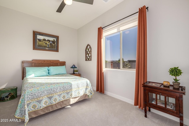 carpeted bedroom featuring baseboards and ceiling fan