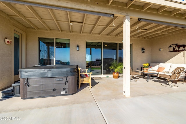 view of patio / terrace featuring an outdoor living space and a hot tub