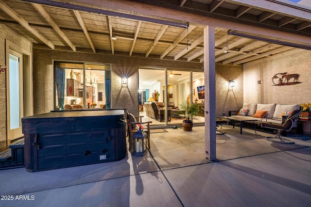 view of patio / terrace with outdoor lounge area and a hot tub