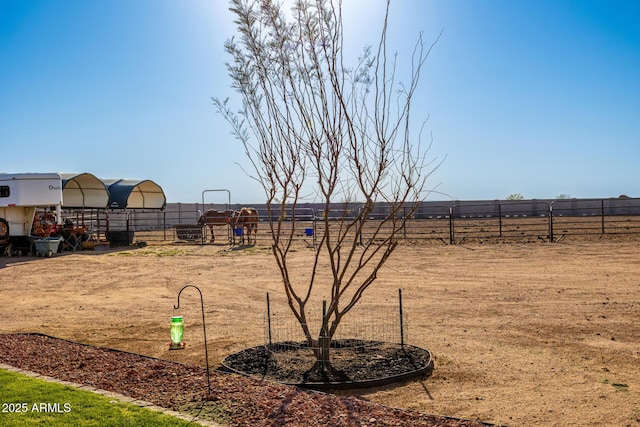 view of yard featuring fence and an outdoor structure
