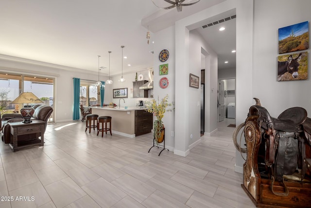 hallway with baseboards, visible vents, and recessed lighting