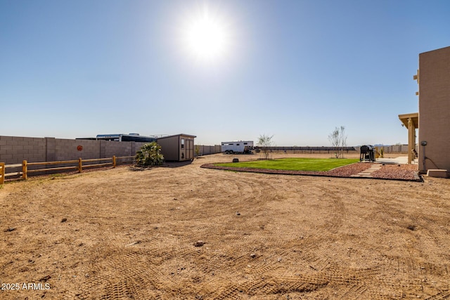 view of yard with an outdoor structure and fence