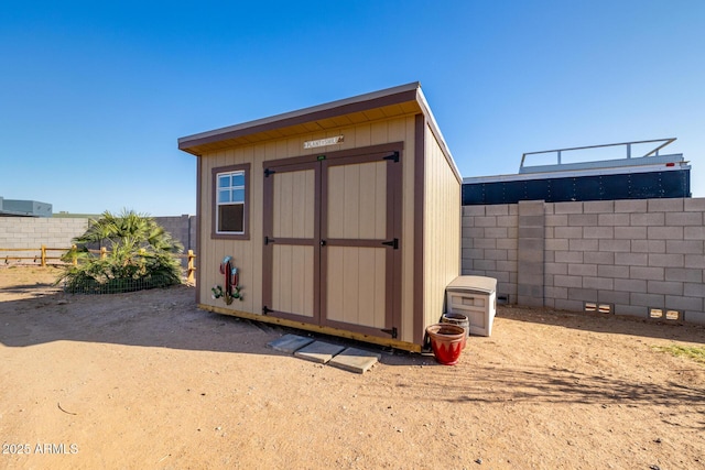 view of shed featuring a fenced backyard