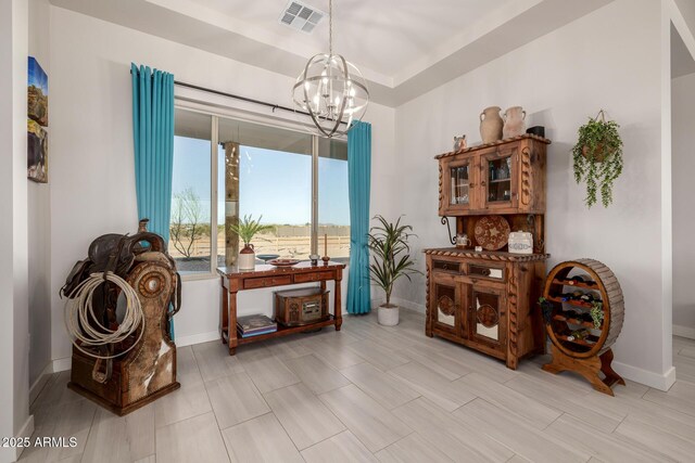 sitting room featuring baseboards, visible vents, and a notable chandelier