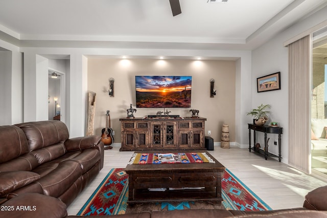 living room featuring visible vents, ceiling fan, wood finished floors, and baseboards