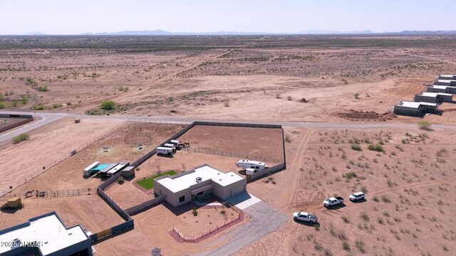 drone / aerial view with a mountain view, a rural view, and view of desert