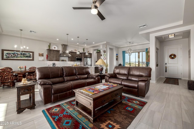 living room with visible vents, recessed lighting, and ceiling fan with notable chandelier