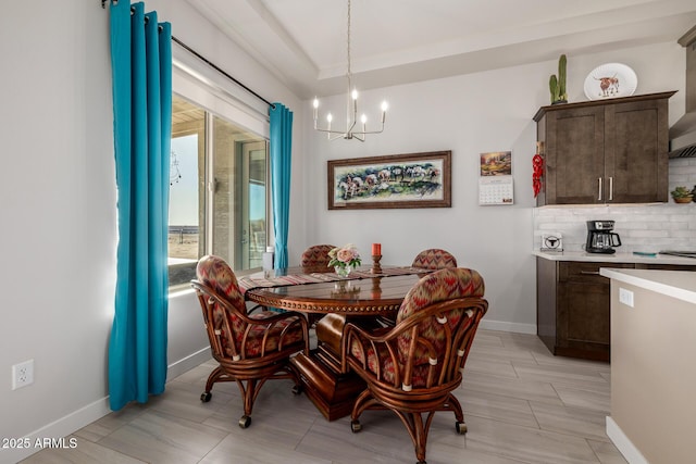dining room featuring baseboards and a chandelier