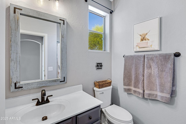 bathroom with toilet and vanity