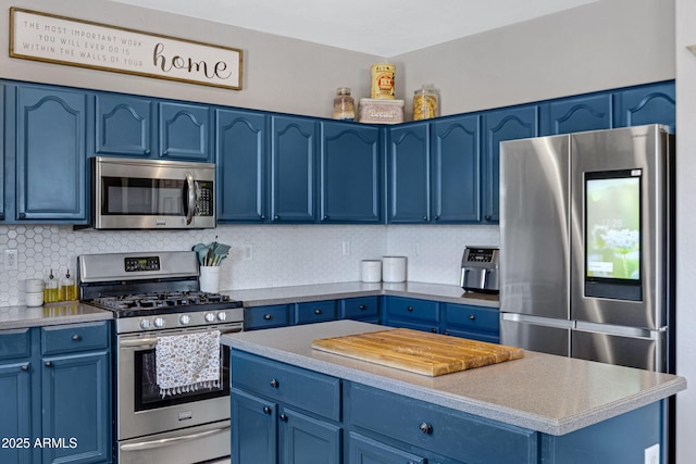 kitchen featuring blue cabinets, backsplash, and appliances with stainless steel finishes