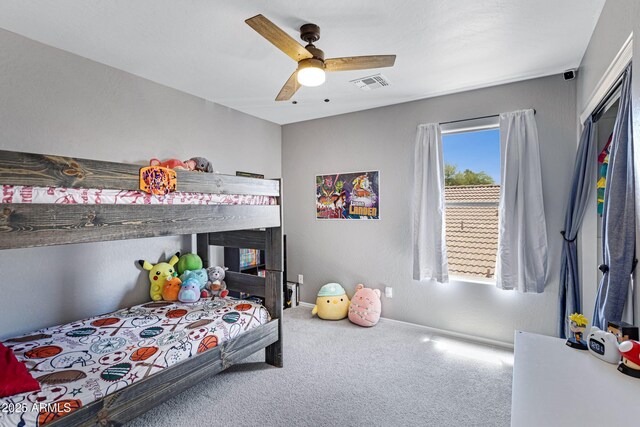 carpeted bedroom with visible vents, ceiling fan, and baseboards