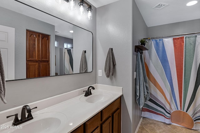 full bath with double vanity, visible vents, tile patterned flooring, and a sink
