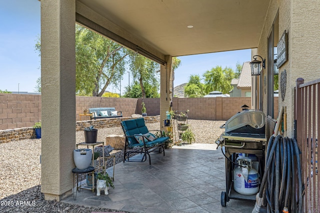 view of patio with grilling area and a fenced backyard
