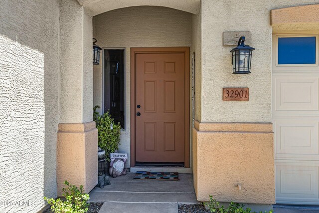 entrance to property with stucco siding