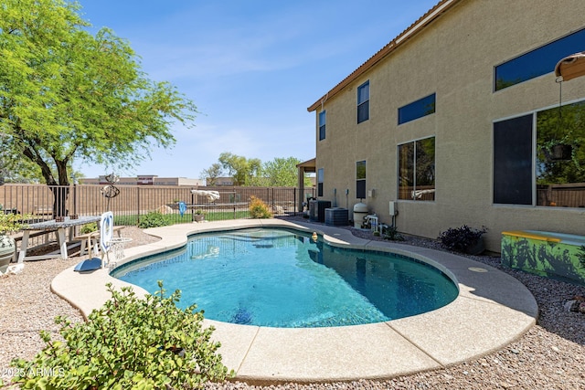 view of swimming pool with central AC, a fenced backyard, a fenced in pool, and a patio area