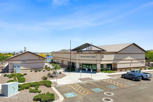 view of building exterior featuring uncovered parking
